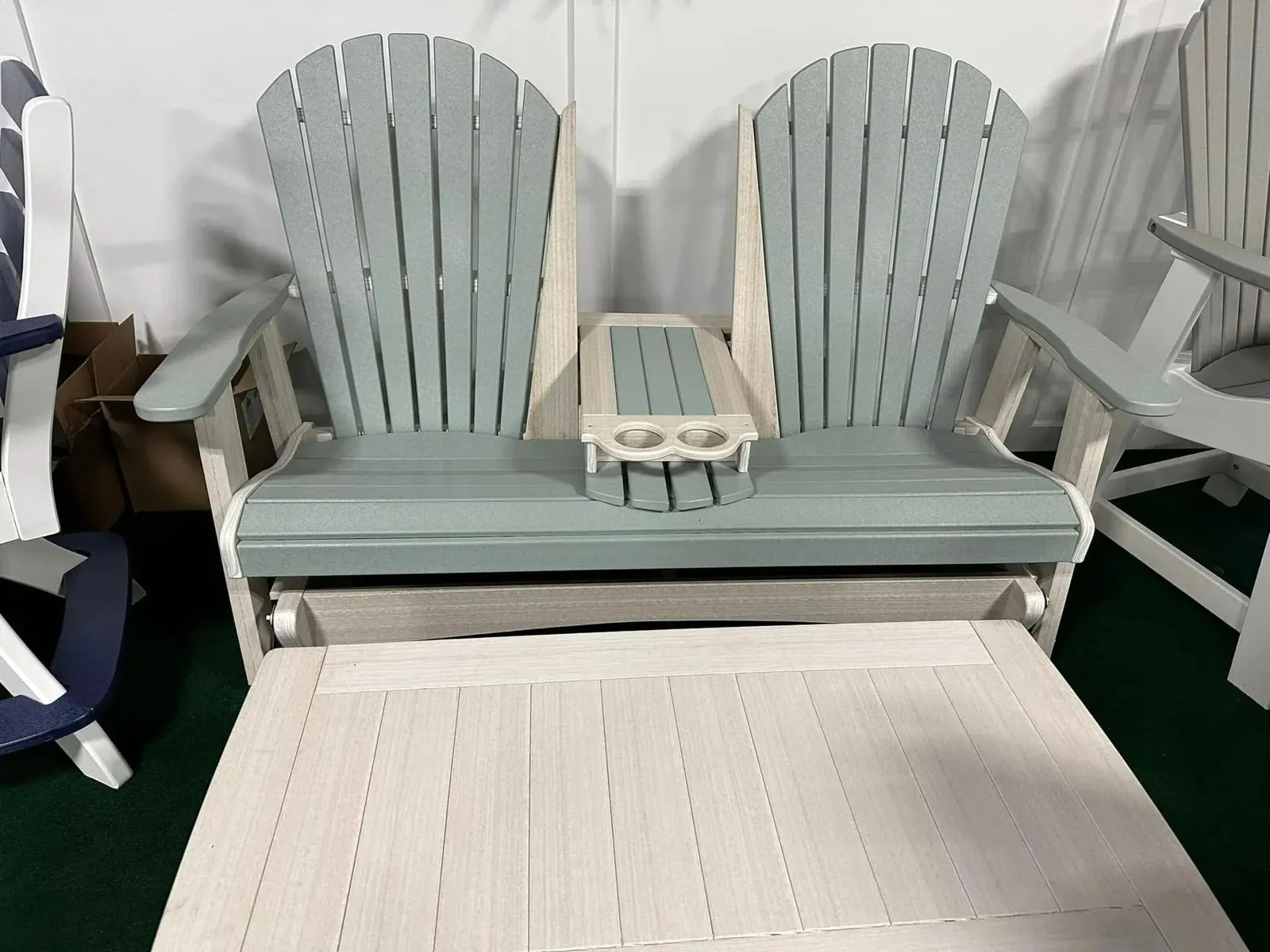 Light blue and white poly glider loveseat with a center console